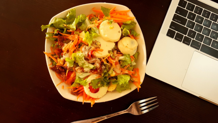 salad beside laptop