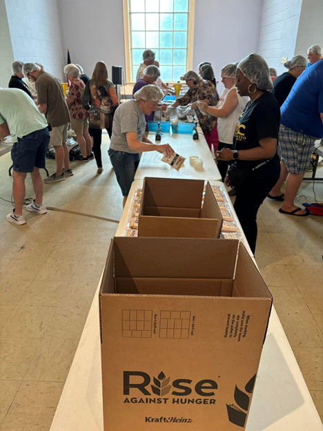 Volunteers packing at Rise Against Hunger Event