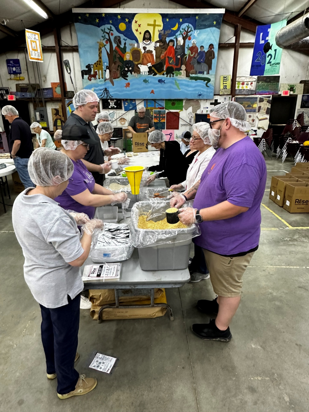 Volunteers filling the meal bags at Rise Against Hunger Event - Sound District